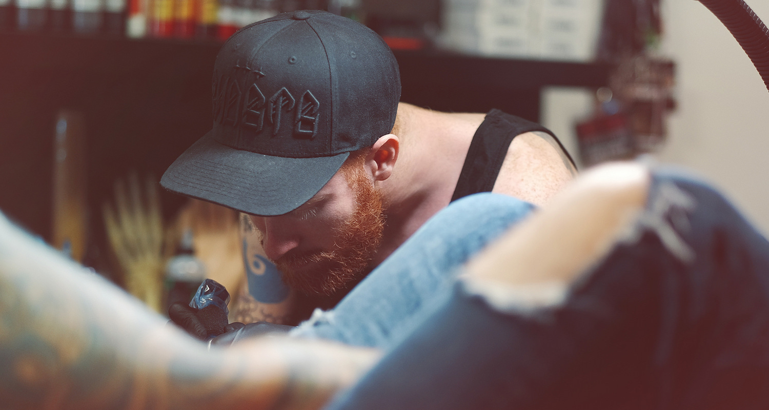 photo of Michael Cloutier tattooing a client